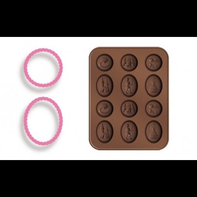 Forma de silicone castanha com cavidades em relevo de coelhos e ovos e duas molduras ovais rosa e branco