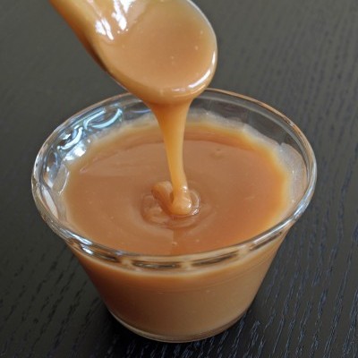 Doce de leite cremoso em recipiente de vidro