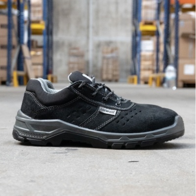 sapatilha de segurança preta Torwalk com sola cinza e preta em piso de armazém