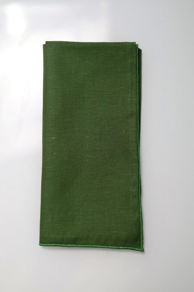 Tecido verde dobrado com costura verde nas bordas