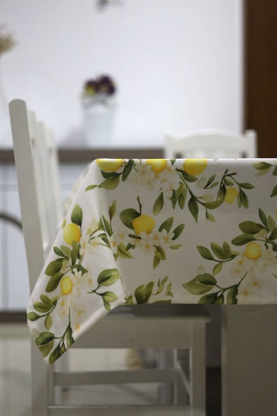Toalha de mesa branca com estampa de limões amarelos e folhas verdes