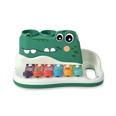 Brinquedo de crocodilo verde com teclado colorido em base branca