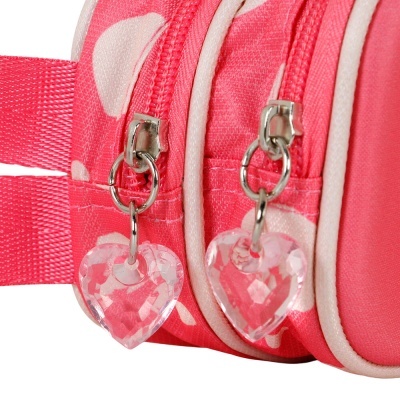 Mochila rosa com bolinhas brancas e fechos com pingentes em forma de coração