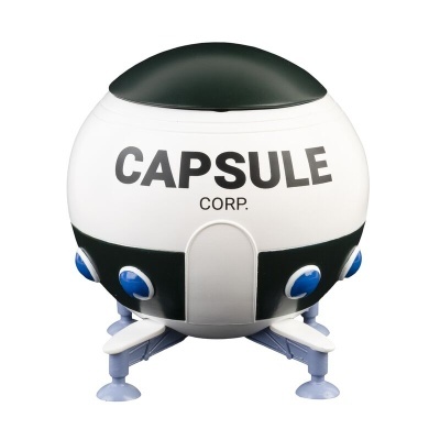 Objeto esférico branco com topo preto e pés, inscrições CAPsULE CORP.