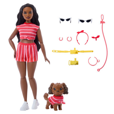 Boneca em roupa de malha rosa e vermelha com cão e acessórios diversos.