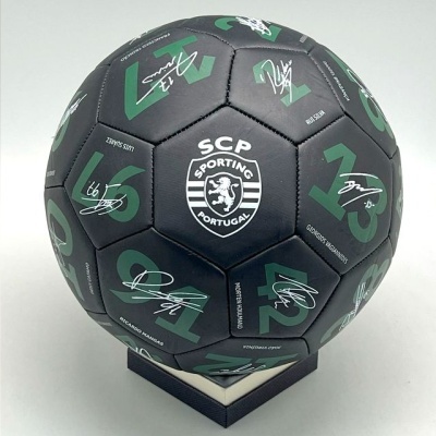 Bola de futebol preta com logótipo e assinaturas