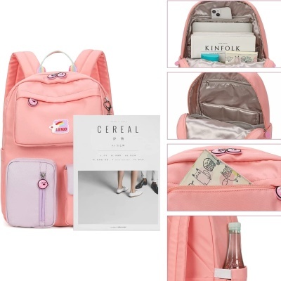 Mochila cor-de-rosa com bolso lilás e detalhes de personagem, múltiplos compartimentos