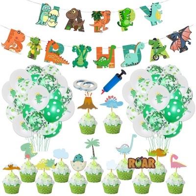 Decoração de festa com tema dinossauros com balões, cupcakes com toppers, banner com dinossauros e instrumentos de decoração