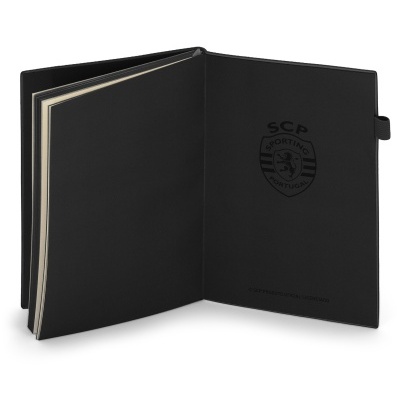 Caderno preto aberto com logotipo SCP Sporting Portugal na capa interna.