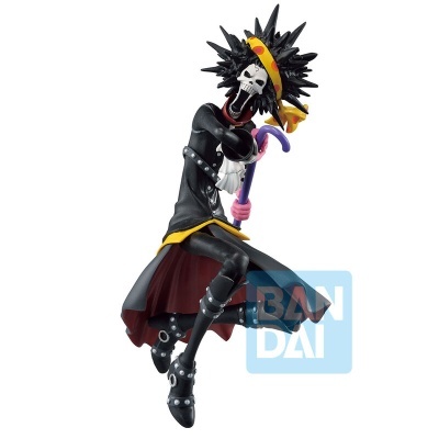 Figura colecionável de esqueleto com roupas preta e vermelha segurando bengala