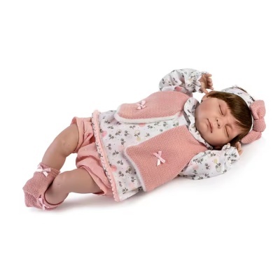 Boneca bebé realista vestida em roupas rosa e brancas deitada