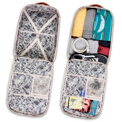 Mala de viagem cinzenta aberta mostrando interior forrado com padrão floral e organizadores com roupas e objetos.