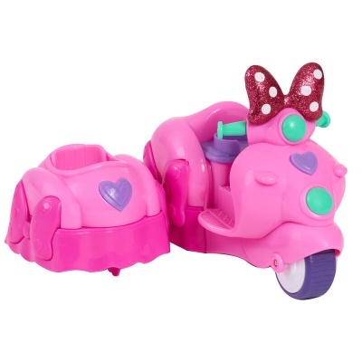 Scooter de brinquedo rosa com laço e compartimento em plástico