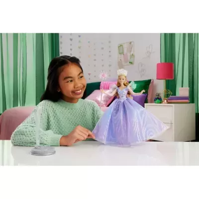 Boneca princesa lilás com varinha e menina em quarto com decoração colorida