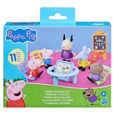 Brinquedo Peppa Pig com personagens em volta de mesa, caixa azul e verde