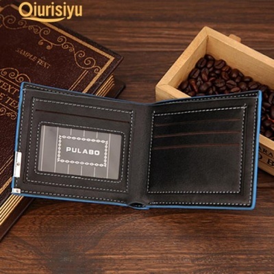 Carteira preta em pele com costura azul e cartão PULABO, junto a livros e grãos de café