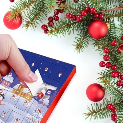 Calendário do advento azul e laranja com ilustrações natalícias e ramos de pinheiro com bagas e bolas vermelhas