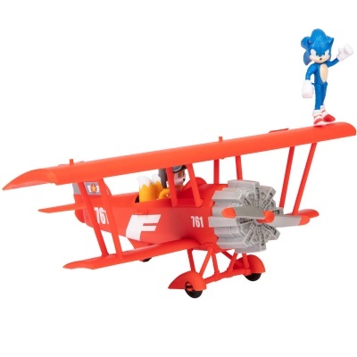 Avião vermelho de brinquedo com personagem azul na asa