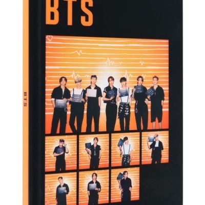 Caderno BTS preto e laranja com fotos dos membros da banda em fundo laranja