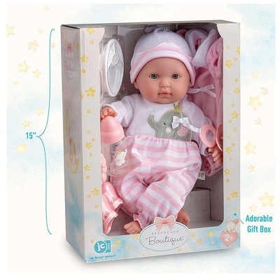 Boneca bebé com pijama rosa às riscas e acessórios numa caixa de presente com estrelas amarelas