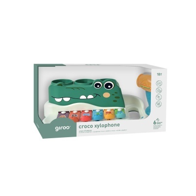 Xilofone infantil verde em forma de crocodilo com teclas coloridas na embalagem