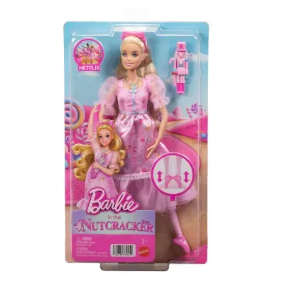 Boneca Barbie vestida com roupa rosa em embalagem de plástico com texto e acessório de soldadinho de chumbo rosa