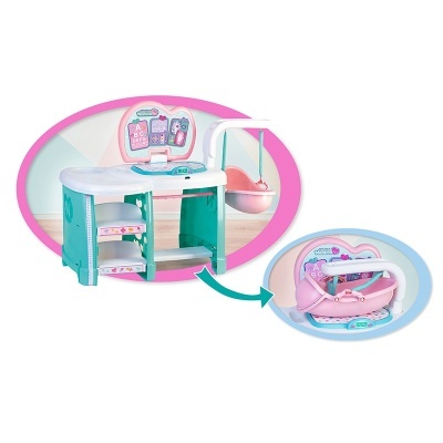 Cozinha de brinquedo rosa, branca e verde-água com balancim e prateleiras.