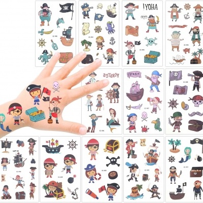 Folhas de autocolantes de piratas aplicados numa mão e espalhados no fundo.