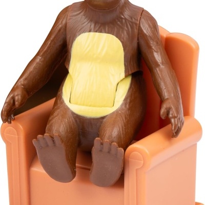 Figura de urso sentado numa cadeira de plástico cor de salmão