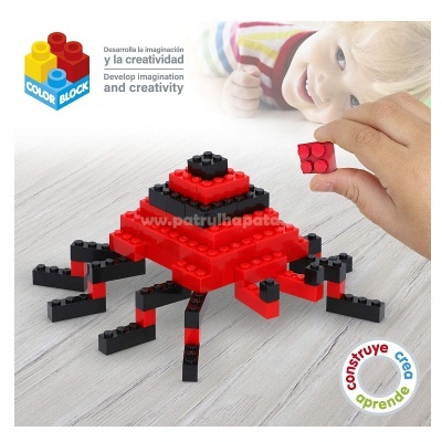 Jogo de blocos de construção em preto e vermelho formando aranha com criança ao fundo.
