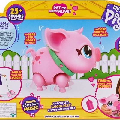 Brinquedo porco rosa interativo em embalagem colorida com texto em inglês