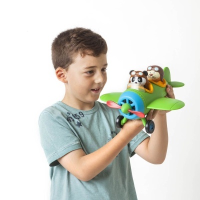 Menino a brincar com avião de brinquedo verde e bonecos