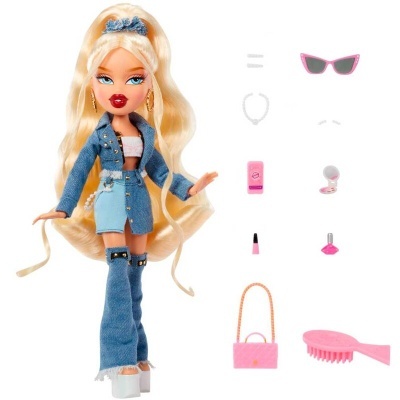 Boneca loira com roupa de tecido denim azul e acessórios variados incluindo óculos, escova e maquilhagem
