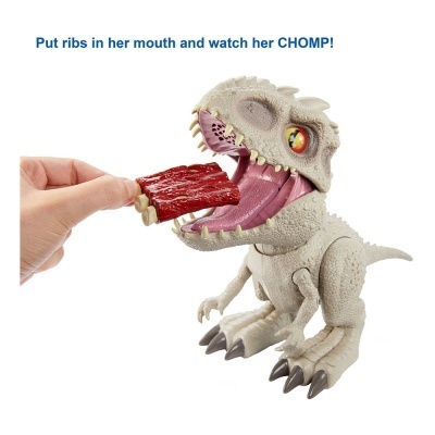 Brinquedo dinossauro cinzento a ser alimentado com peça vermelha, texto azul em fundo branco