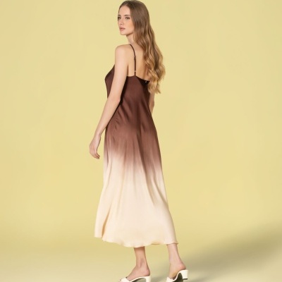 Vestido comprido de alças com gradiente castanho para bege e sapatos brancos.