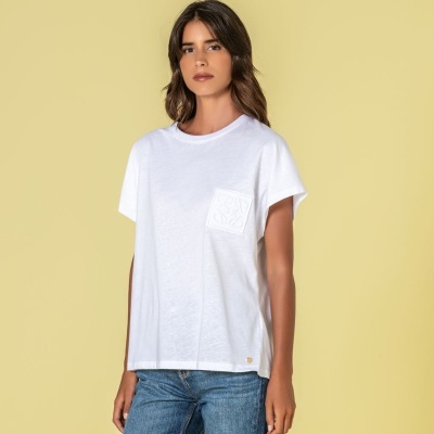 T-shirt branca com bolso texturado usada com jeans azuis