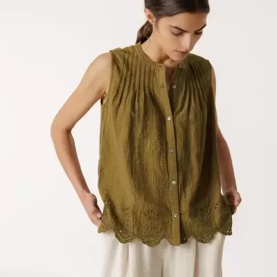 Blusa verde-oliva feminina sem mangas com botões e calças largas claras