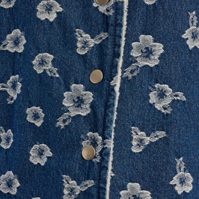 Tecido de ganga azul com padrão floral branco e botões metálicos