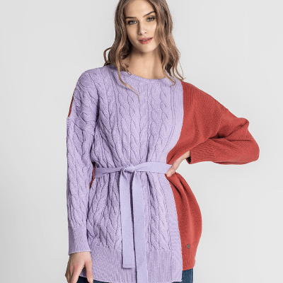 Camisola de malha lilás e vermelha com padrão de tranças e cinto na cintura.