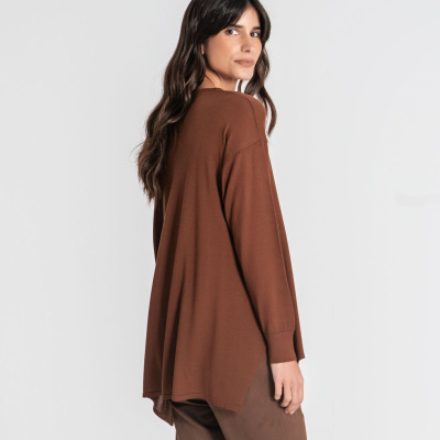 Mulher de costas com camisola castanha e calças castanhas