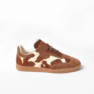 Tênis castanho e branco com padrão animal print e sola castanha