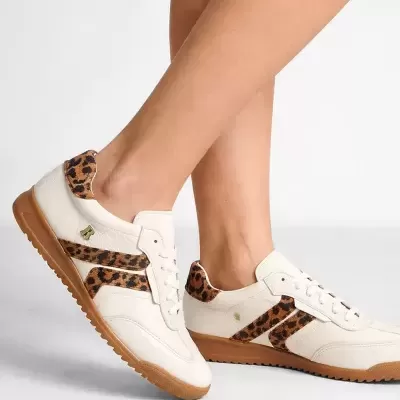 Ténis brancos com padrão animal print castanho e preto nas laterais e na traseira em fundo branco.