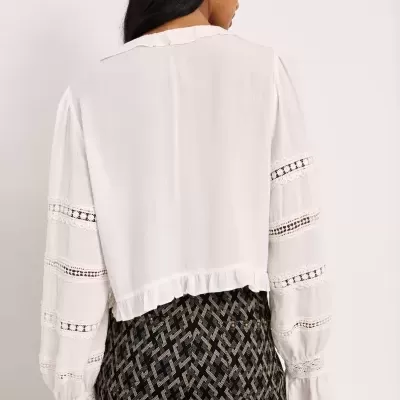 Blusa branca com mangas longas decoradas vista pelas costas