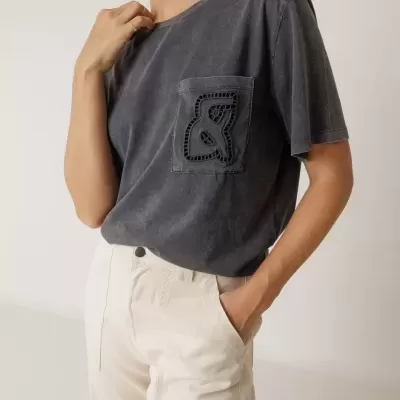 T-shirt cinzenta escura com bolso bordado e calças brancas