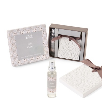 Conjunto de perfume e placa decorativa em gesso branco com fita castanha e caixa decorativa.