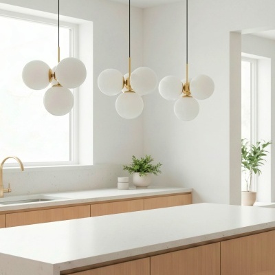 Cozinha moderna com candeeiros pendentes de globos brancos e detalhes dourados