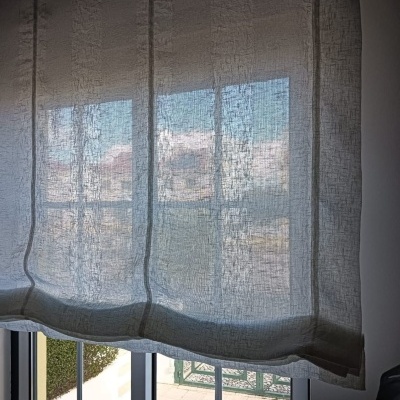 Cortina branca transparente em janela com vista exterior