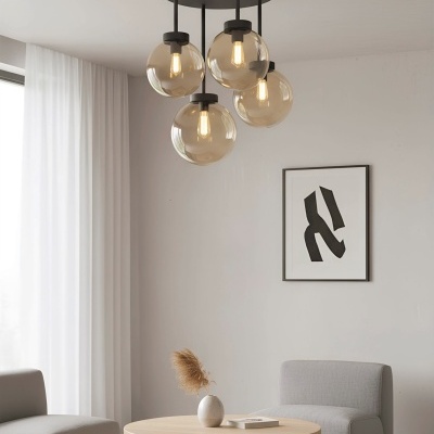 Candeeiro de teto moderno com globos de vidro sobre mesa de centro e poltronas numa sala minimalista