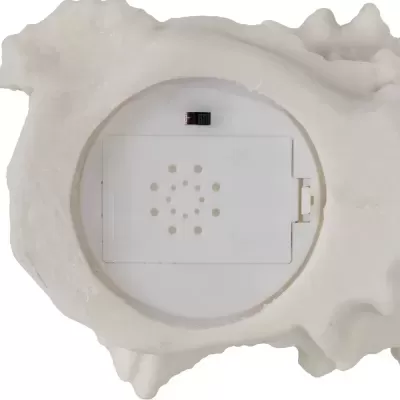 Parte traseira de objeto decorativo em forma de concha com compartimento de pilhas
