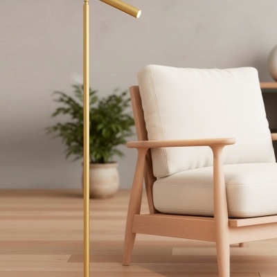 Candeeiro dourado minimalista junto a cadeira de madeira clara com almofadas brancas